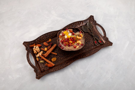 Ashure, Turkish dessert porridge in bowl on metal tray. traditional turkish cuisine. Sweet pudding also called as Noah's pudding or Noah's Dessert.の写真素材