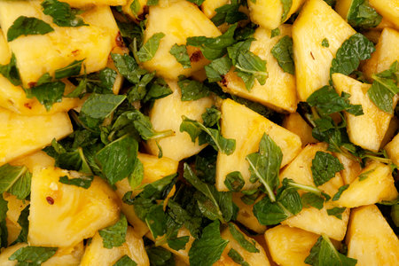 Pineapple slices with mint, close-up, selective focus. Sweet fruit dessert. Delish ripe Pineapple in cane sugar syrup with mint leaves. Popular chinese fruit salad.の写真素材