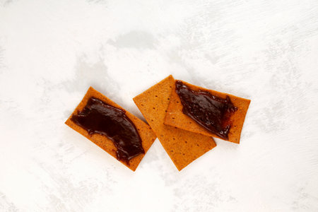 Bread crispy chips with Vegemite spread. Tomato rye crisps and yeast extract based sauce. Typical aussie snack.の写真素材