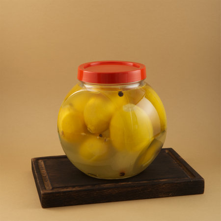 Savory salted lemon fruits in glass jar, close-up. Delicious topping for appetizer and different dishes, natural flavor enhancer.の写真素材
