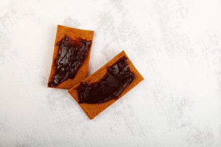 Tomato taste rye crisps for breakfast. Roasted Aussie savory chips with vegemite. Vegemite is a very popular yeast based spread in Australia.の写真素材