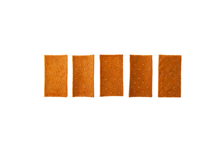 Crisps with paprika in row on white background, top view. Design element, copy space. Crispy rye bread. dehydrated food. Wholegrain crispbread, rye crisp.の写真素材