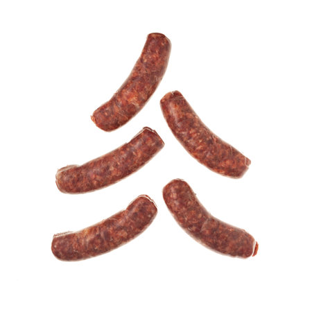 Raw sausages with paprika for barbecue grill on white background. Natural meat processed foods. Chorizo sausage lie in form alternative Christmas tree.の写真素材