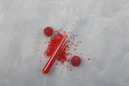 Tartrazine powder and sweets. Food additive E102. Food coloring CI 19140 used in different candies, lollipops and marmalade. Tartrazine is a synthetic azo dye.の写真素材