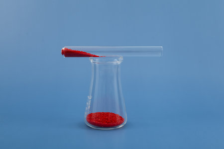 Tartrazine powder in glass flask and test tube. Food coloring. CI 19140 or FD&C. Food additive E102. Tartrazine is a synthetic azo dye.の写真素材