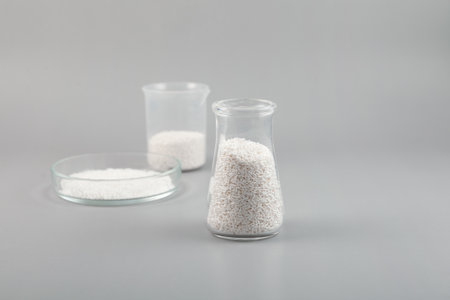 Potassium sorbate, oblong pellets in lab dishes. Granular potassium salt of sorbic acid. Food additive E202 used as food preservative, prevent mold and microbes and to increase shelf life.の写真素材