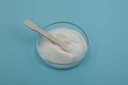 Glucono-delta-lactone, also known as gluconolactone. Pure GDL in Petri dish with ceramic spatula....