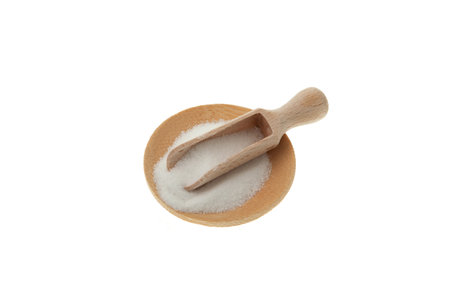 Food additive E575 in wooden scoop on white background. Glucono-delta-lactone, also known as gluconolactone. Pure GDL, white odorless crystalline powder Produced by the aerobic oxidation of glucose.の写真素材