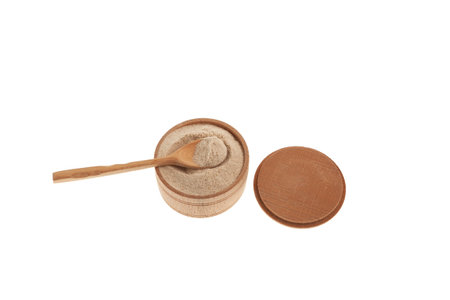 Medicinal organic isabgol husk or psyllium husks (Plantago ovata) in wooden bowl on white background. Dietary supplements containing psyllium are sold mainly to aid weight loss.の写真素材