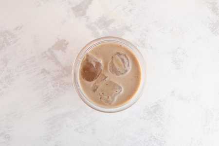 Susu Kurma or dated milk in glass, top view. Milkshake with dates or palm fruits. Popular beverage to energy while fasting. Delicious iced drink. Protein cocktail.の写真素材