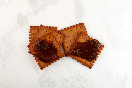 Crackers and Vegemite spread, top view. Vegemite is very popular thick Australian healthy food spread made from leftover brewers yeast extract.の写真素材