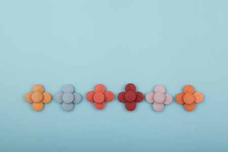 Dye or pigments in the form of tablets on blue background. Food additives for coloring food products and Easter eggs.の写真素材