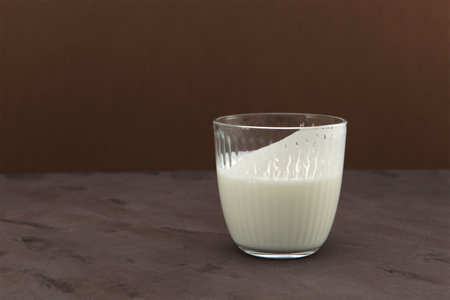 Ayran or Kefir on brown background, side view. Buttermilk made with yogurt. Fermented sour milk.の写真素材