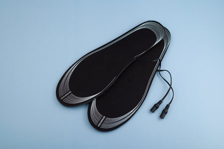 Pair of porous insoles of universal size with pre-installed heat elements. Heating Insoles. Perfect for winter walks, outdoor work, fishing, running, hiking, and more.の写真素材