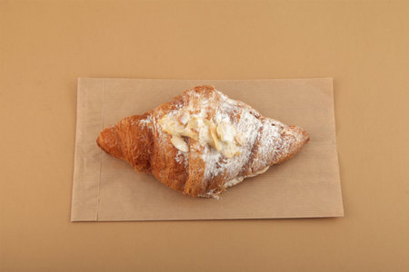 French croissant with almond and sugar powder. Delicious snack for morning coffee.の写真素材
