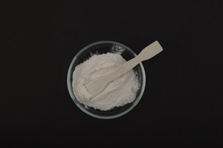 Sodium Carboxymethyl Cellulose Powder, NaCMC in Petri dish, top view. Food additive E466. Thickening...
