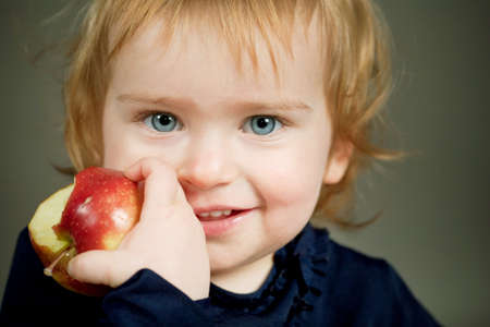 girl eats an appleの写真素材
