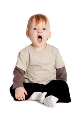 little cute boy yawns isolated on whiteの写真素材