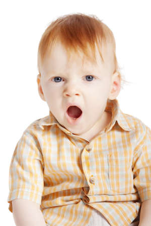 little boy yawning isolated on white backgroundの写真素材
