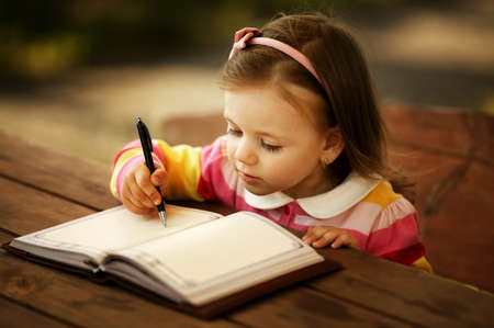 a little girl learning to writeの写真素材