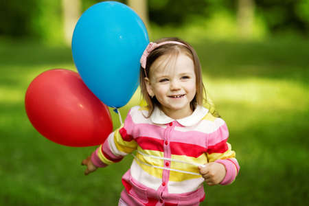 little girl plays with balloonsの写真素材