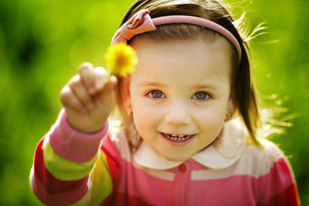 little funny girl with dandelionの写真素材
