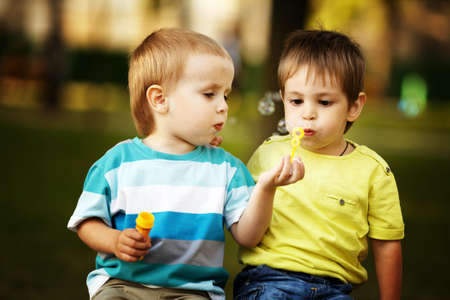little boys playing with bubblesの写真素材