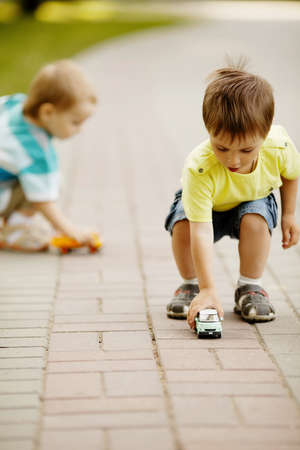 little boy plays with toy carの写真素材