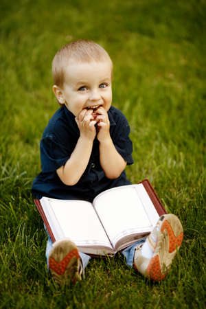 little happy boy with bookの写真素材