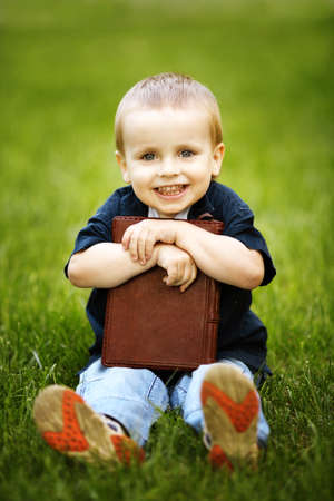 little happy boy with bookの写真素材