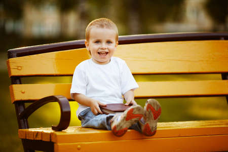 little happy boy with bookの写真素材