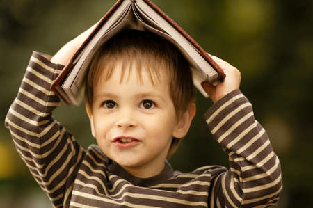 boy with book on his headの写真素材