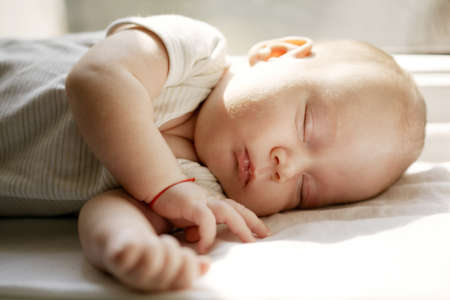 baby sleeping white blanket on window