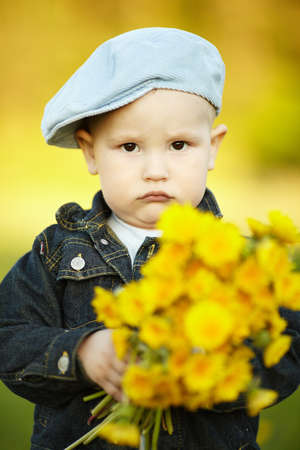 cute little boy with dandelionsの写真素材