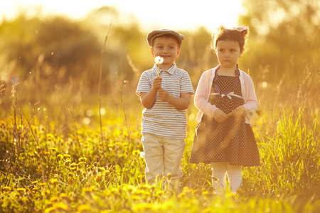cute boy and girl on summer field