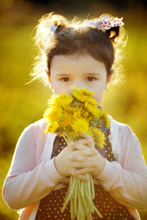 cute little girl with dandelionsの写真素材