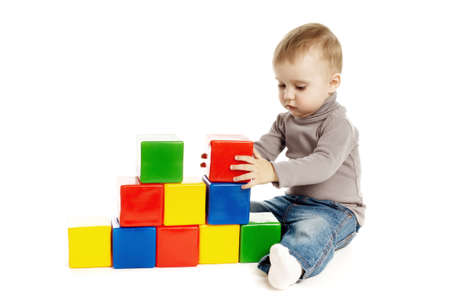 child playing with toy cubes, isolated on whiteの写真素材