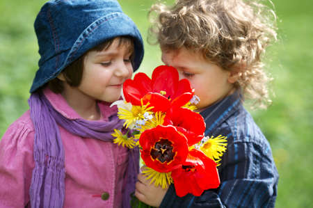 boy and girl with bouquet of flowersの写真素材