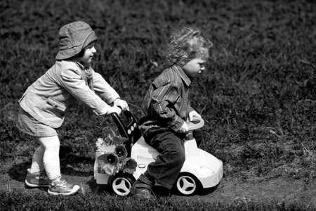 boy and girl in park with toy car