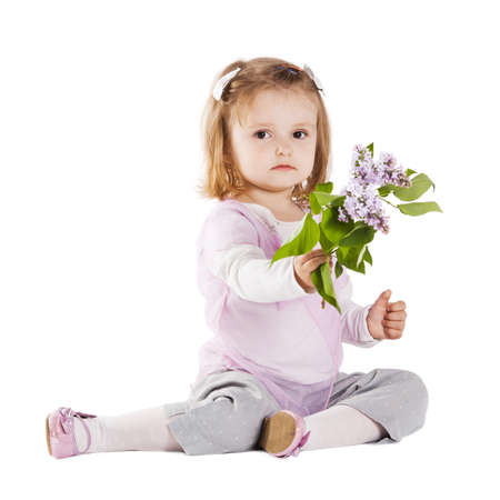little girl giving a branch of lilacの写真素材