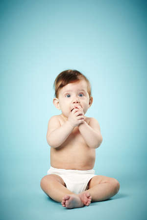 cute happy baby on blue backgroundの写真素材