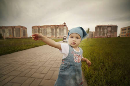little girl points to the side. wide angle photoの写真素材