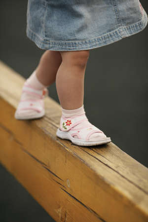 little girl goes on horizontal barの写真素材