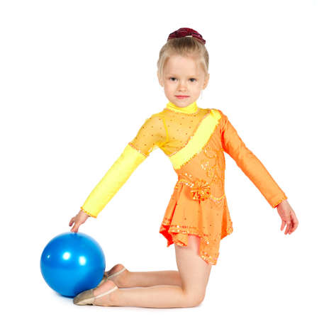 Beautiful girl gymnast with a ball isolated on whiteの写真素材