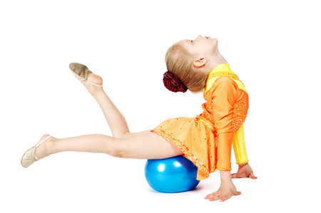 Beautiful girl gymnast with a ball isolated on whiteの写真素材
