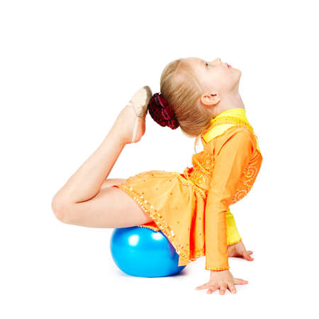 Beautiful girl gymnast with a ball isolated on whiteの写真素材