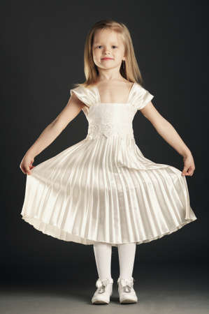 little beautiful girl on dark backroundの写真素材
