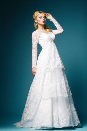 beautiful bride in wedding dress on blue backgroundの写真素材