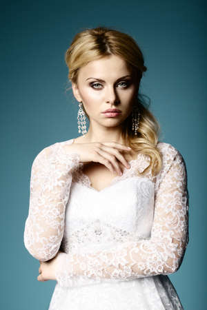 beautiful bride in wedding dress on blue backgroundの写真素材