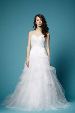 beautiful bride in wedding dress on blue backgroundの写真素材